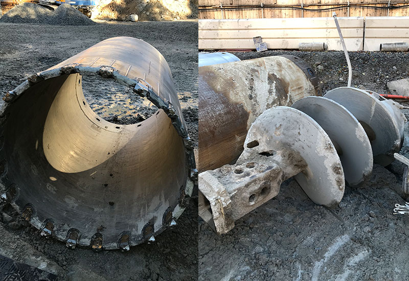 On the left are the steel pipes that are drilled down into the ground while extracting the loosened soil. Each pipe has teeth that allow it to be drilled into the ground. These need to be replaced at regular intervals due to wear. On the right is the screw used to extract the soil.