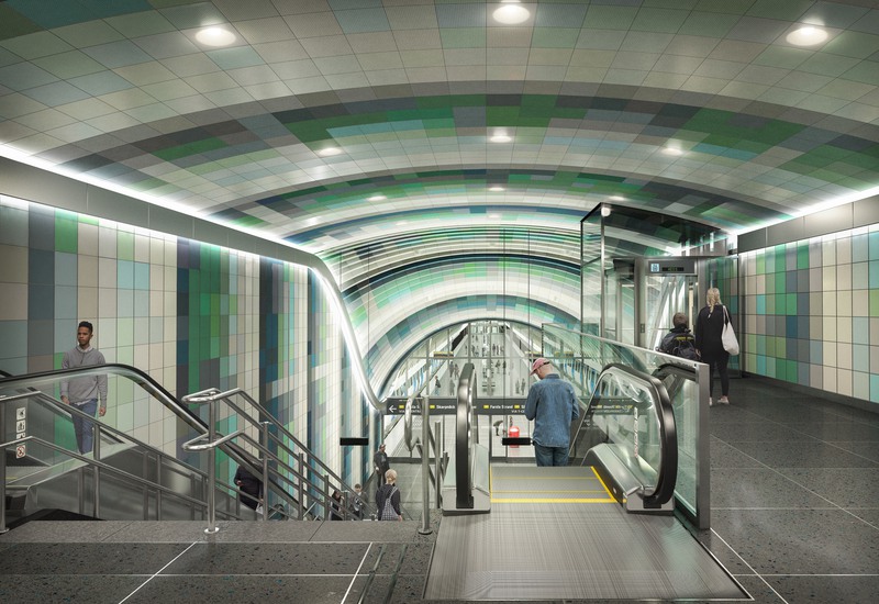 Visionsbild av framtida stationen Arenastaden. Rulltrappa ner till plattformen med kaklade väggar och tag i olika nyanser av grönt.