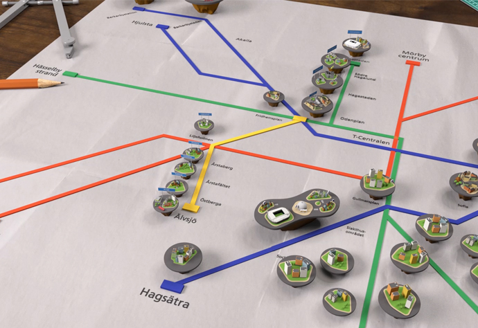 Skärmavbild från animerad film som visar ett skrivbord där framtidens tunnelbanekarta ligger med nya stadsområden utplacerade som små öar.