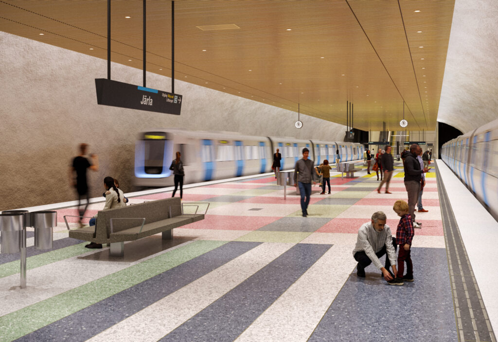En grupp människor som står på en plattform med ett golv i olika färger. Tåg kommer in till plattformen.
